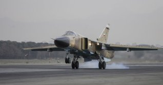 A Sukhoi Su-24M Fencer D aircraft lands on the runway during an Islamic Republic of Iran Air Force military drill at the Shahid Lashkari Tactical Air Base (TAB-1) in Tehran, Iran, on April 16, 2009. (Photo by Ali Rafiei / Middle East Images via AFP)