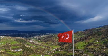 After the rainy weather, the Turkish flag waves as a rainbow appears in the sky, Kocaeli, Türkiye, March, 1, 2026. (İHA Photo)