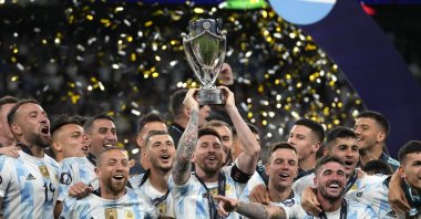 Argentina's Lionel Messi holds a trophy as he celebrates with his teammates after winning the Finalissima soccer match between Italy and Argentina at Wembley Stadium, London, U.K., June 1, 2022. (AP Photo)