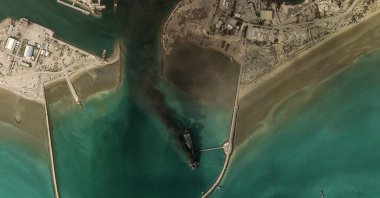 This handout satellite image taken by 2026 Planet Labs PBC shows smoke billowing from a vessel following an explosion from the port of Bandar Abbas along the strait of Hormuz, March 2, 2026. (AFP Photo)