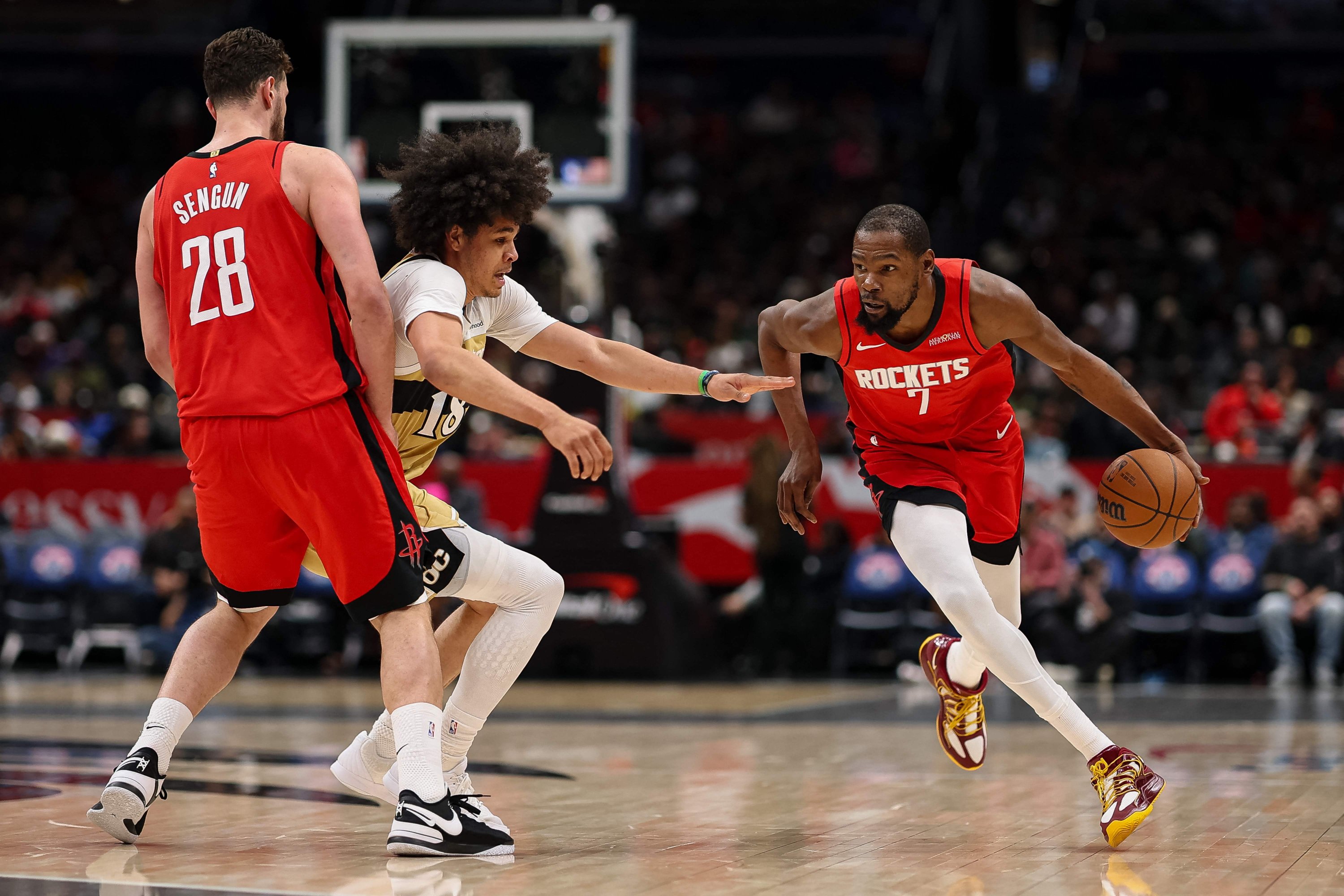 Houston Rockets' Kevin Durant (R) drives to the basket as Alperen Şengün (R) sets a pick against Washington Wizards' Kyshawn George during the first half at Capital One Arena, Washington, U.S., Mar. 2, 2026. (AFP Photo)
