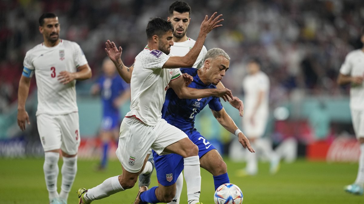 USMNT's Sergino Dest (R) fights for the ball with Iran's Milad Mohammadi during the World Cup group B match between Iran and the United States at the Al Thumama Stadium, Doha, Qatar, Nov. 29, 2022. (AP Photo)