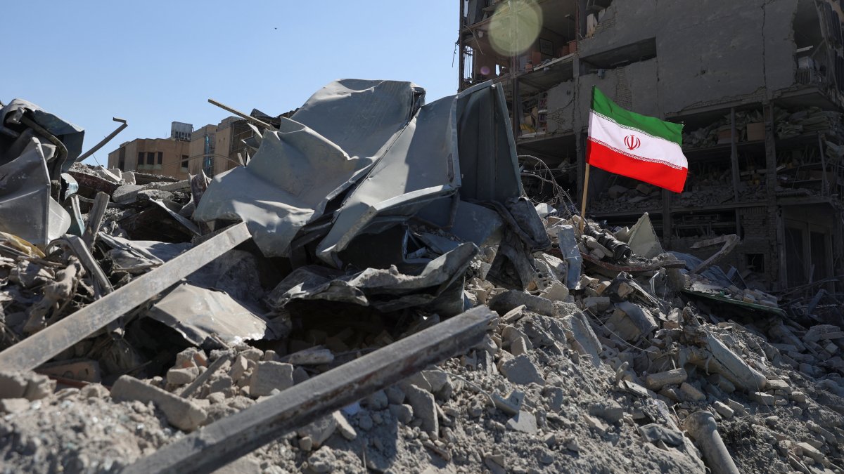 The national flag of Iran flies in the wind as debris lies scattered in the aftermath of an Israeli and U.S. strike on a police station, in Tehran, Iran, March 3, 2026. (Reuters Photo)