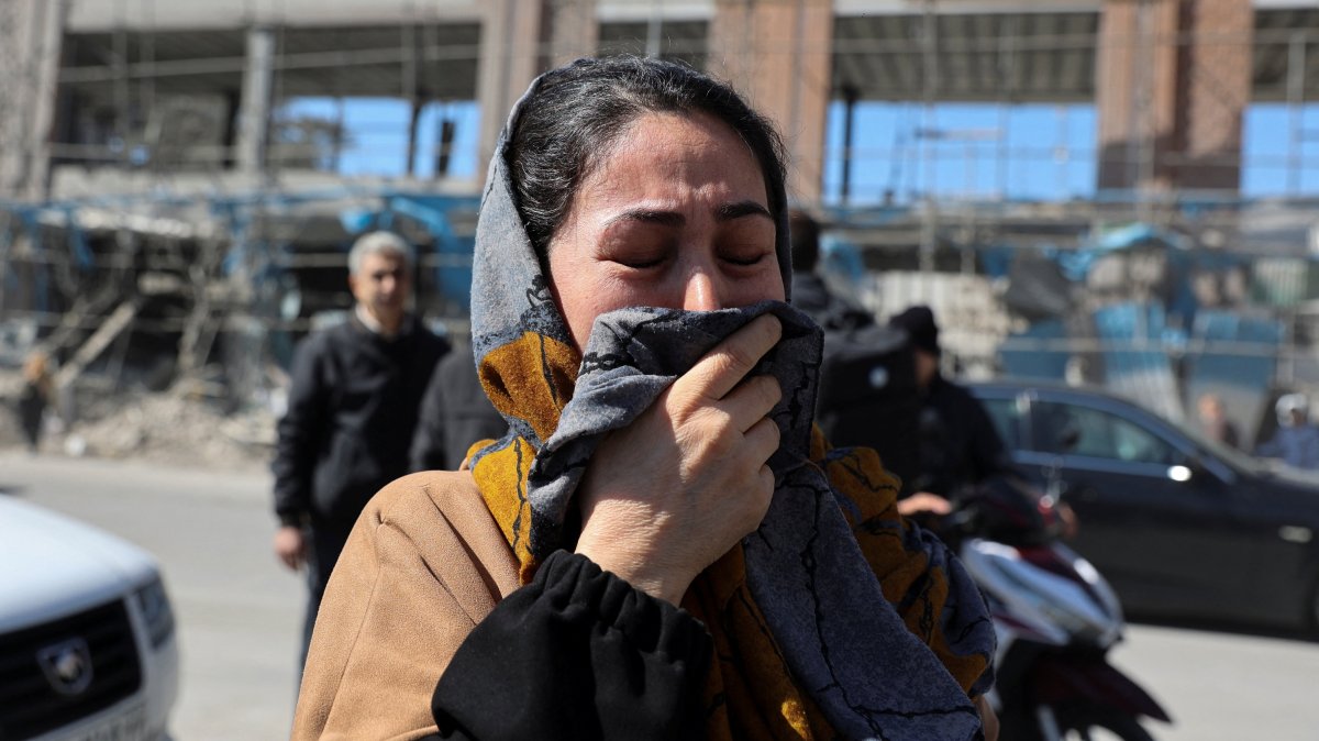 A woman reacts on the street following an Israeli and U.S. strike on a police station, in Tehran, Iran, March 3, 2026. (Reuters Photo)