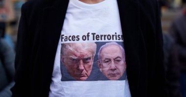 A person wears a t-shirt featuring images of U.S. President Donald Trump and Israeli Prime Minister Benjamin Netanyahu during a protest against the war in Iran, New York, U.S., March 2, 2026. (AFP Photo)