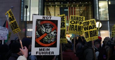 Demonstrators display signs as they march past Trump Tower, while taking part in a protest against the U.S.-Israel conflict with Iran, after the U.S. and Israel launched strikes on Iran, in New York City, U.S., March 2, 2026. (Reuters Photo)