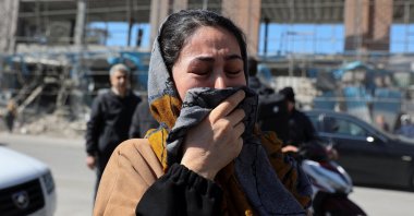 A woman reacts on the street following an Israeli and U.S. strike on a police station, in Tehran, Iran, March 3, 2026. (Reuters Photo)