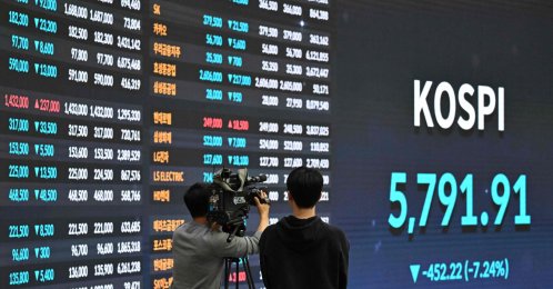 A cameraman films in front of an electronic screen showing South Korea's benchmark stock index (KOSPI) at the Korea Exchange in Seoul, South Korea, March 3, 2026. (AFP Photo)