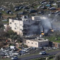 Israeli bulldozers demolish an apartment building belonging to the Salhab family near the illegal settlement of Hagai, south of the occupied West Bank city of Hebron, on Feb. 18, 2026. (AFP Photo)