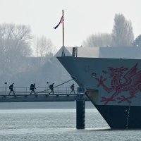 Troops arrive to board HMS Dragon, a Royal Navy Type 45 Daring-class air-defense destroyer warship, moored outside HM Naval Base Portsmouth, on the south coast of England, March 4, 2026. (AFP Photo)