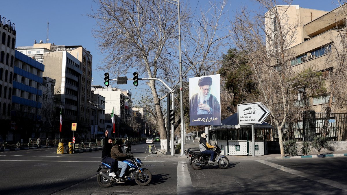 Vehicles pass by a sign in tribute to Iran's late Supreme Leader Ayatollah Ali Khamenei on a street in Tehran, Iran, March 4, 2026. (Reuters Photo)