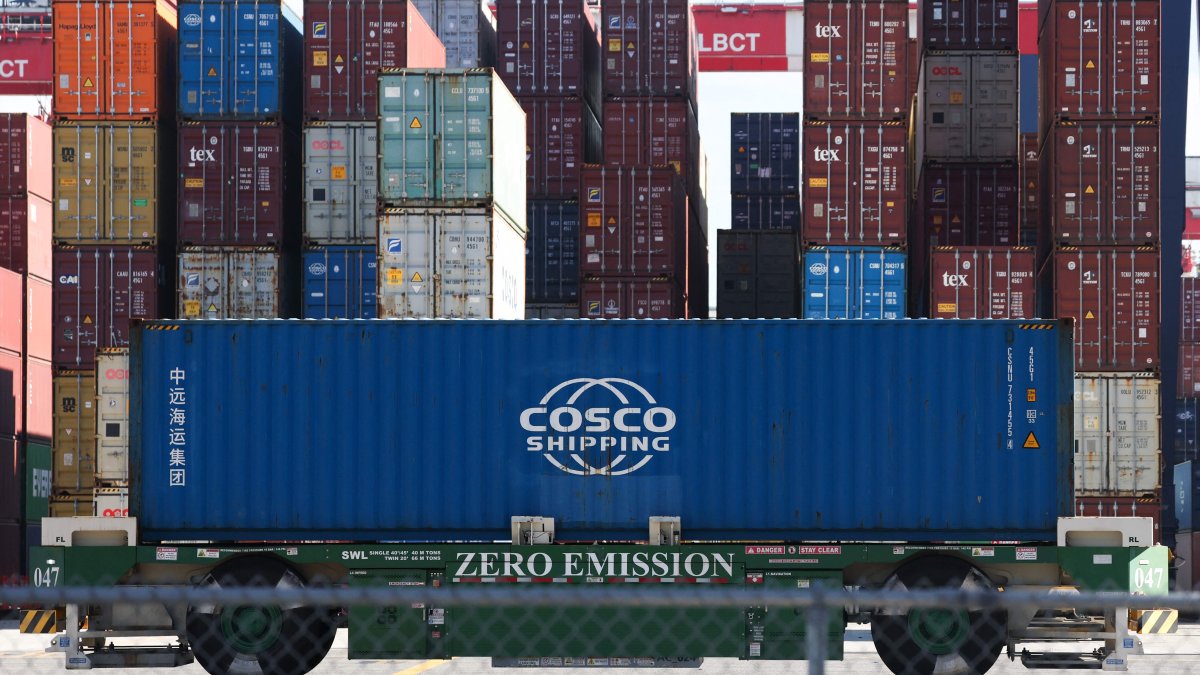 An automated guided vehicle container handler moves a Cosco shipping container at the Port of Long Beach, California, U.S., Jan. 14, 2026. (AFP Photo)