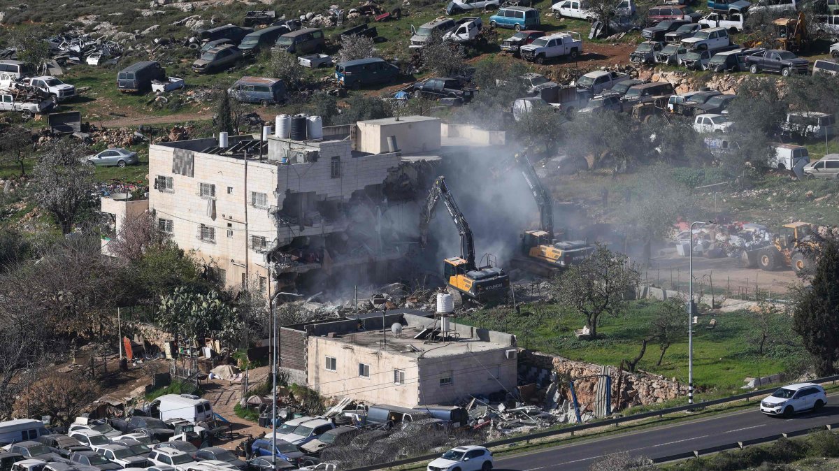 Israeli bulldozers demolish an apartment building belonging to the Salhab family near the illegal settlement of Hagai, south of the occupied West Bank city of Hebron, on Feb. 18, 2026. (AFP Photo)