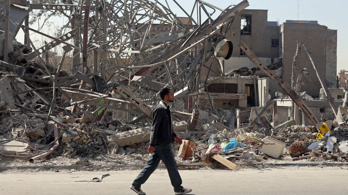 A man walks past destroyed buildings following airstrikes in central Tehran, Iran, March 4, 2026. (AFP Photo)