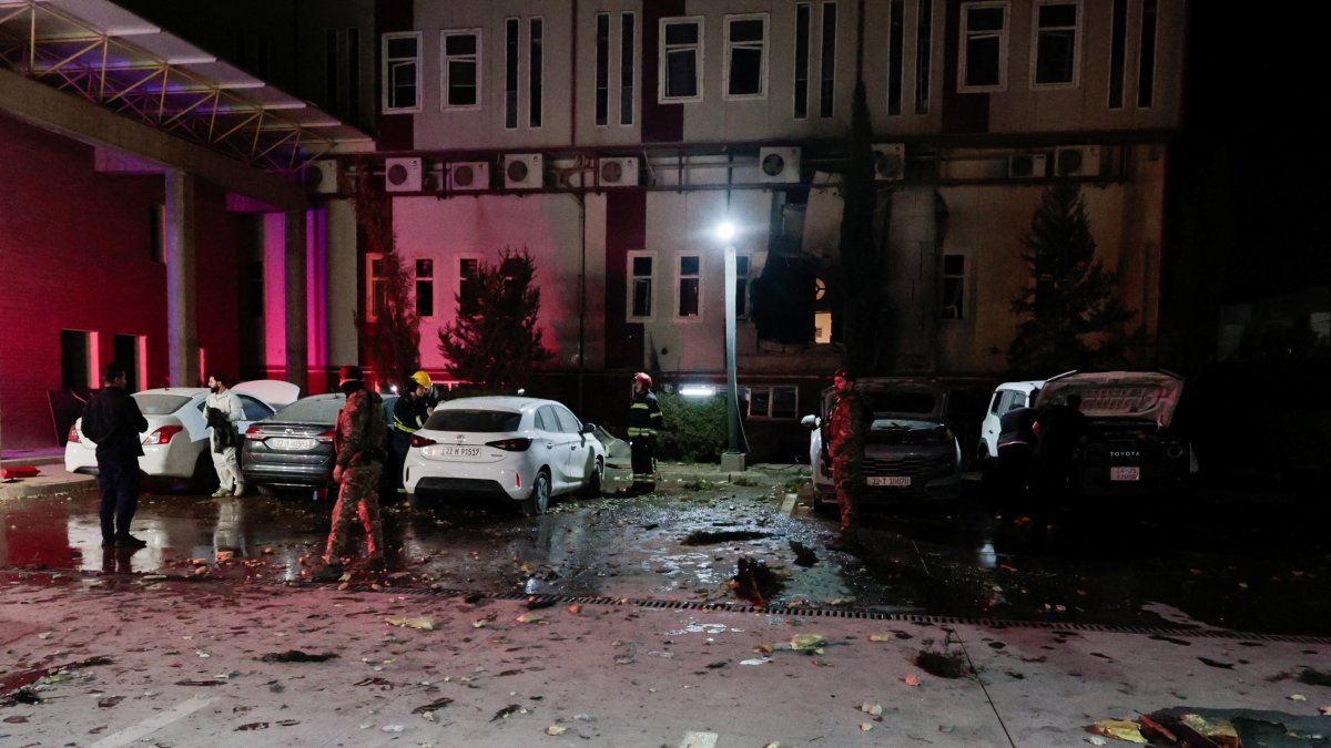 People gather near debris from a drone that fell onto a building near Irbil airport, amid the U.S.-Israeli conflict with Iran, in the Ankawa district of Irbil, Iraq, March 4, 2026. (Reuters Photo)