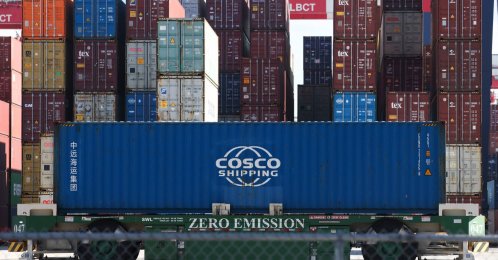 An automated guided vehicle container handler moves a Cosco shipping container at the Port of Long Beach, California, U.S., Jan. 14, 2026. (AFP Photo)