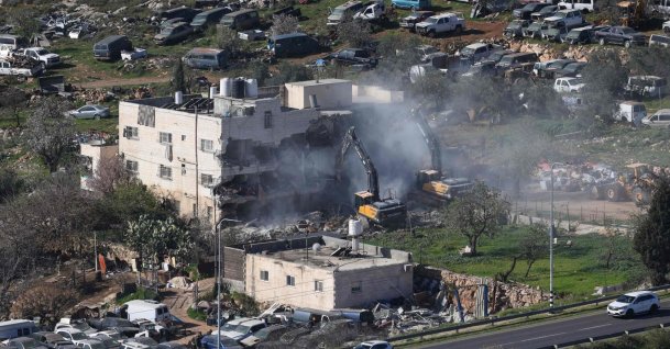 Israeli bulldozers demolish an apartment building belonging to the Salhab family near the illegal settlement of Hagai, south of the occupied West Bank city of Hebron, on Feb. 18, 2026. (AFP Photo)