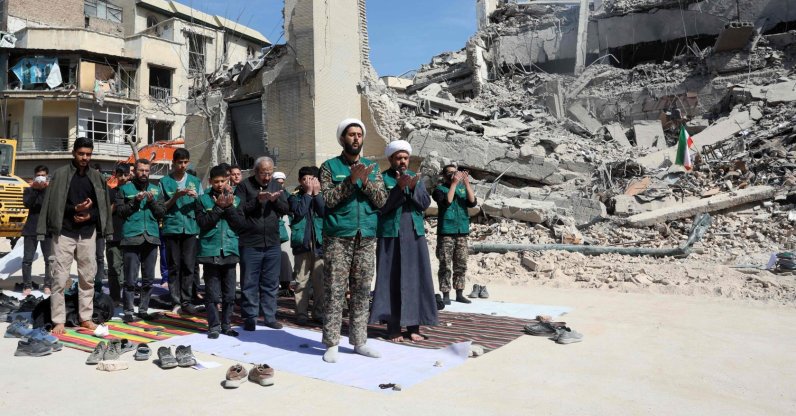 Iranian clerics and volunteers who are helping clear the streets pray next to the rubble of a police station destroyed in Israeli airstrikes in central Tehran, Iran, March 4, 2026. (AFP Photo)