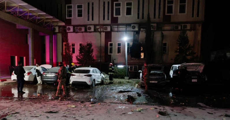 People gather near debris from a drone that fell onto a building near Irbil airport, amid the U.S.-Israeli conflict with Iran, in the Ankawa district of Irbil, Iraq, March 4, 2026. (Reuters Photo)