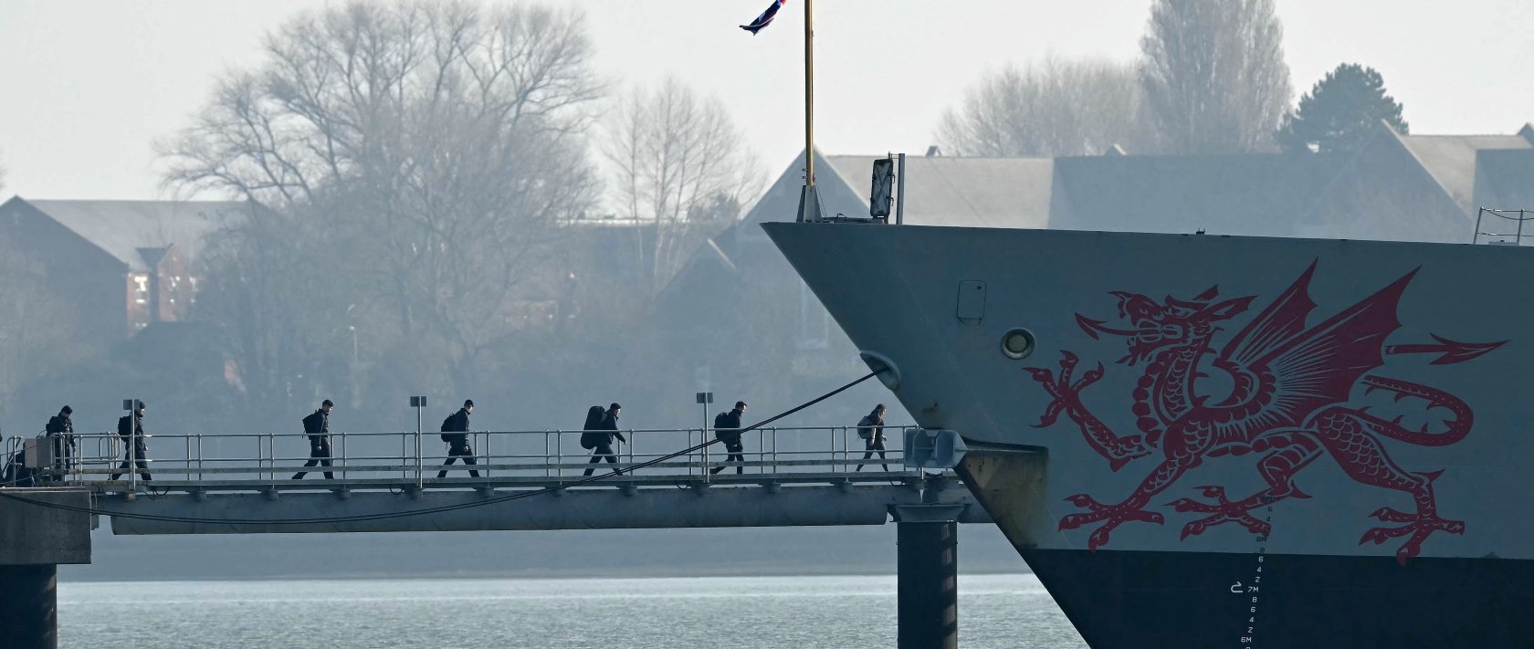 Troops arrive to board HMS Dragon, a Royal Navy Type 45 Daring-class air-defense destroyer warship, moored outside HM Naval Base Portsmouth, on the south coast of England, March 4, 2026. (AFP Photo)