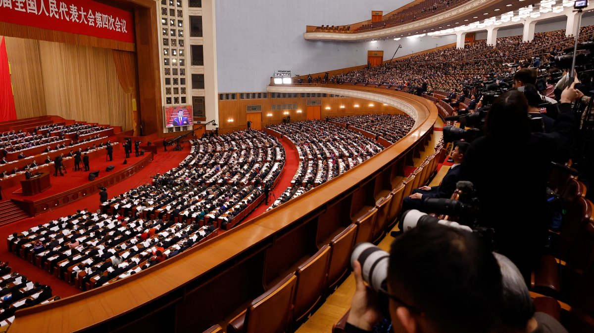 A screen broadcasts Chinese President Xi Jinping as journalists and delegates attend the opening session of the National People's Congress (NPC), Beijing, China, March 5, 2026. (Reuters Photo)