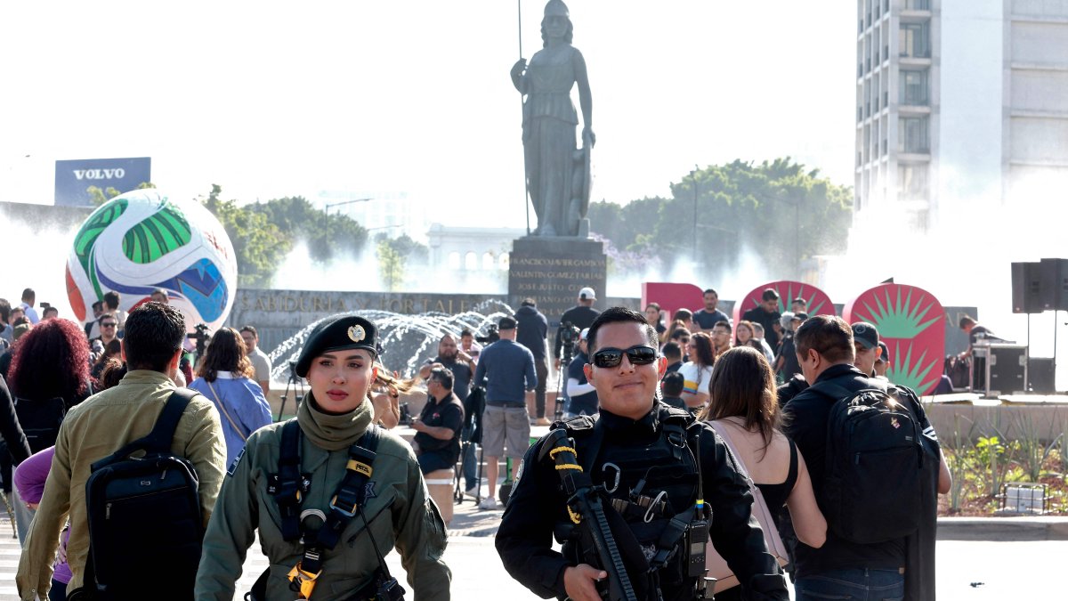 Two police officers guard the area after a giant football and a 3D sign with the number 100 were installed at the roundabout where the "La Minerva" statue stands, as part of the 100 days leading up to the 2026 FIFA World Cup, Guadalajara, Jalisco, Mexico, March 3, 2026. (AFP Photo)