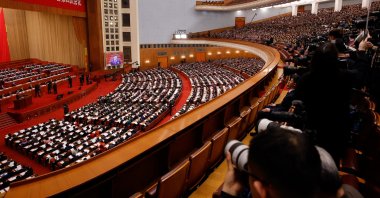 A screen broadcasts Chinese President Xi Jinping as journalists and delegates attend the opening session of the National People's Congress (NPC), Beijing, China, March 5, 2026. (Reuters Photo)