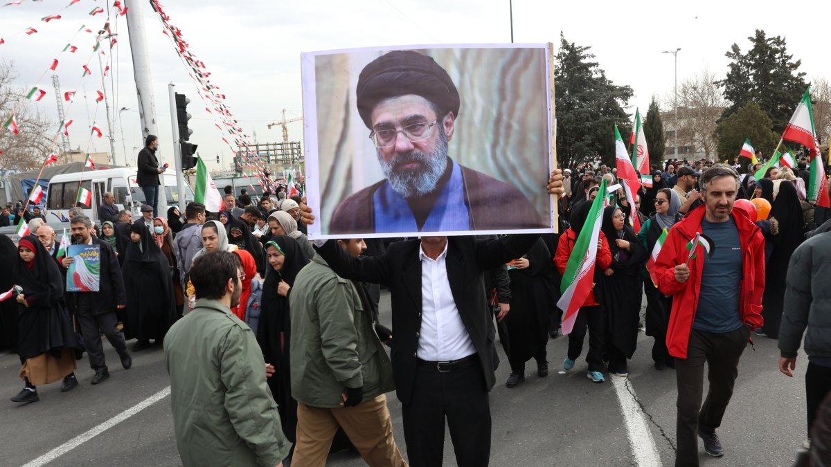 An Iranian man holds a picture of Mojtaba Khamenei, the son of the Iranian Supreme Leader, as he takes part in celebrations of the 47th anniversary of the Islamic Revolution, Tehran, Iran, Feb. 11, 2026. (EPA Photo)