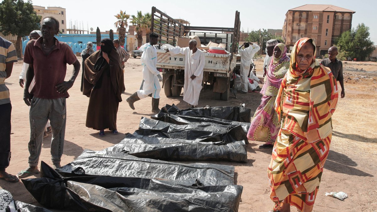 Relatives check the body bags of victims of Sudan’s two-year conflict after the Sudanese Red Crescent transferred the remains from makeshift graves to a local cemetery, Khartoum, Sudan, Jan. 11, 2026. (AP Photo)