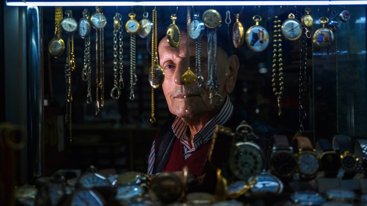 Arif Kocaman looks at his collection of watches in his shop, Istanbul, Türkiye, Feb. 10, 2026. (AA Photo)