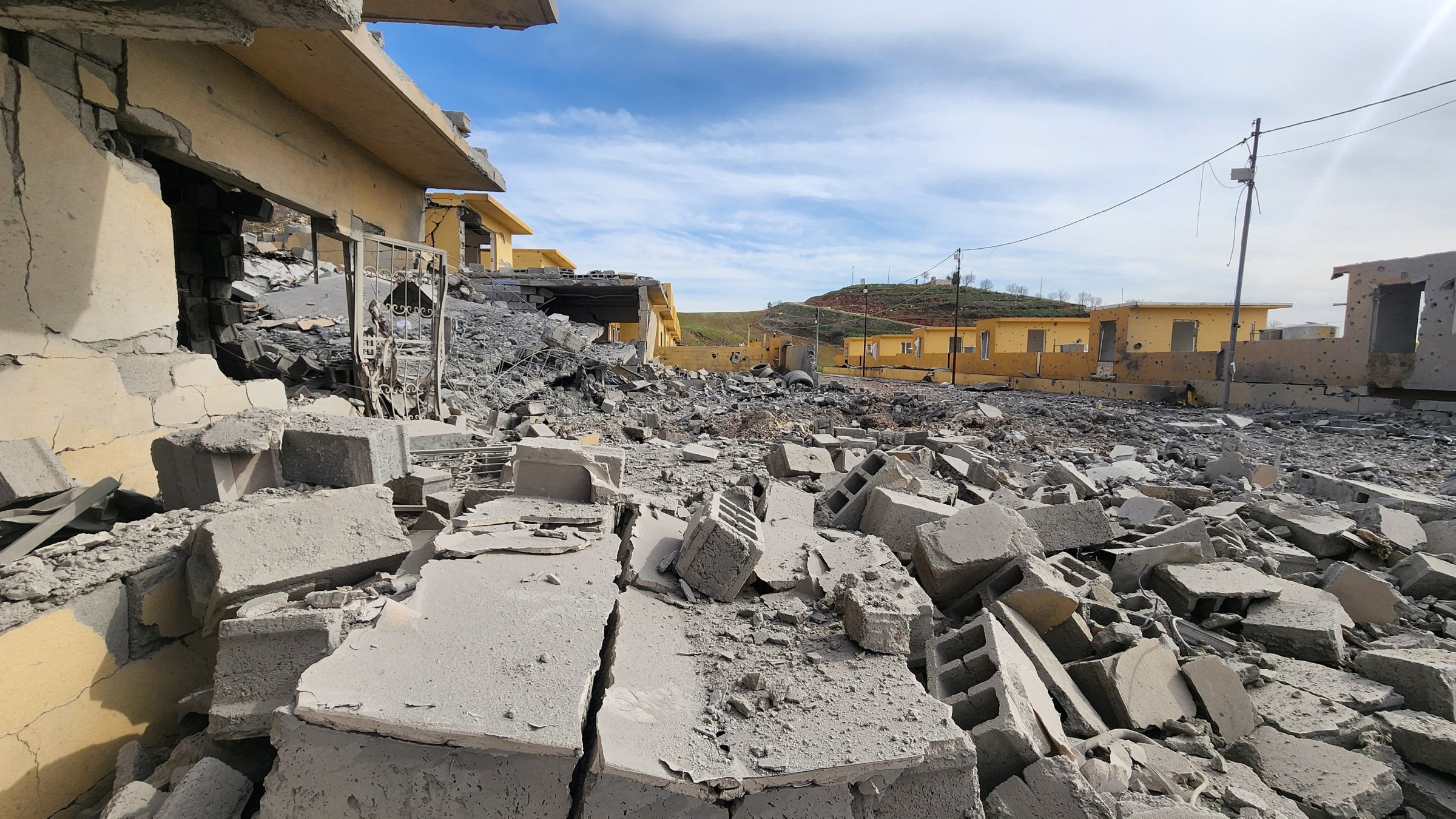 Rubble of destroyed buildings lies following, what the security sources say, a drone struck an arms depot in an attack on the headquarters of an Iranian Kurdish opposition group in which two fighters were wounded, amid the U.S.-Israeli conflict with Iran, in the town of Dekala in Iraq's KRG-held region, March 4, 2026. (Reuters Photo)