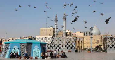People sit as birds fly, amid the U.S.-Israeli war with Iran, Tehran, Iran, March 5, 2026. (Reuters Photo)