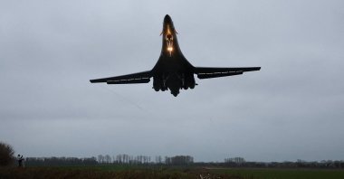 A person looks up as a USAF B1-B bomber prepares to land at RAF Fairford airbase, which also hosts United States Air Force (USAF) personnel, amid the U.S.-Israeli conflict with Iran, in Fairford, Britain, March 6, 2026. (Reuters Photo)