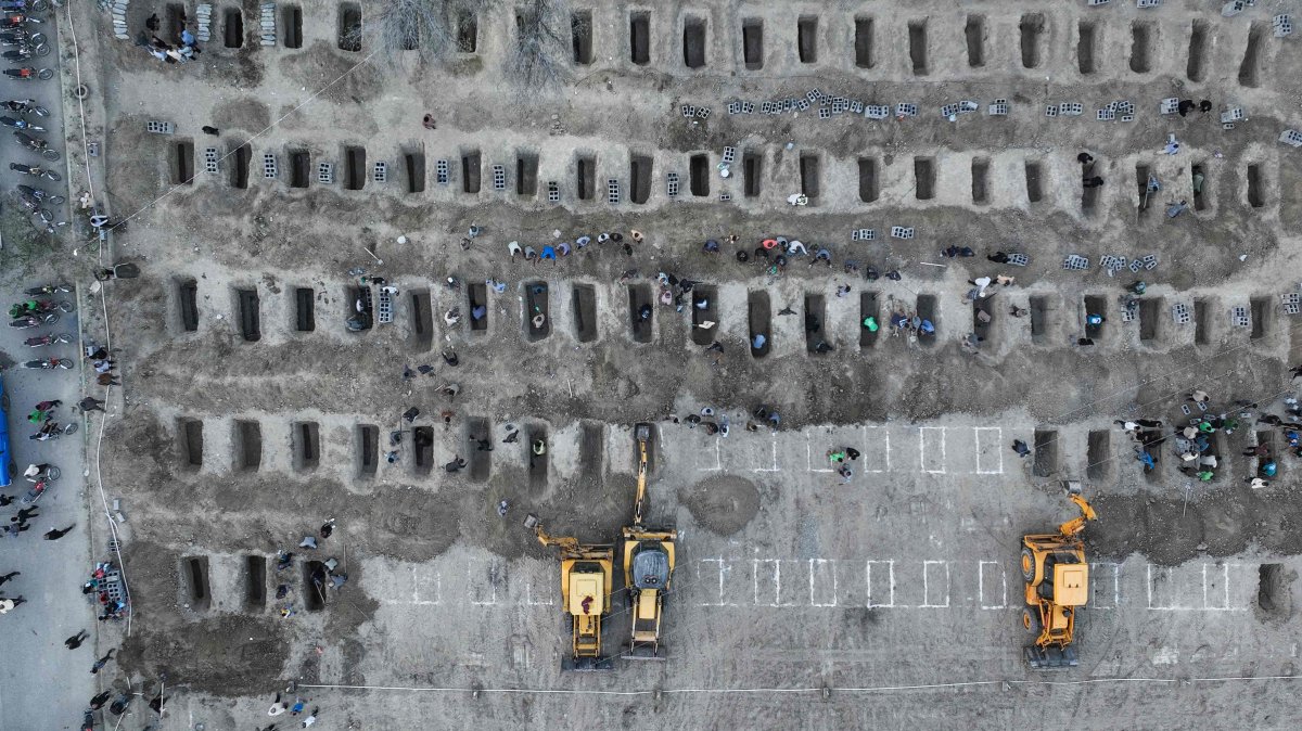 In this aerial handout picture released by the Iranian Press Center, mourners dig graves during the funeral for children killed in a reported strike on a primary school in Minab, Hormozgan province, Iran, March 3, 2026. (AFP Photo)