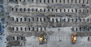 In this aerial handout picture released by the Iranian Press Center, mourners dig graves during the funeral for children killed in a reported strike on a primary school in Minab, Hormozgan province, Iran, March 3, 2026. (AFP Photo)
