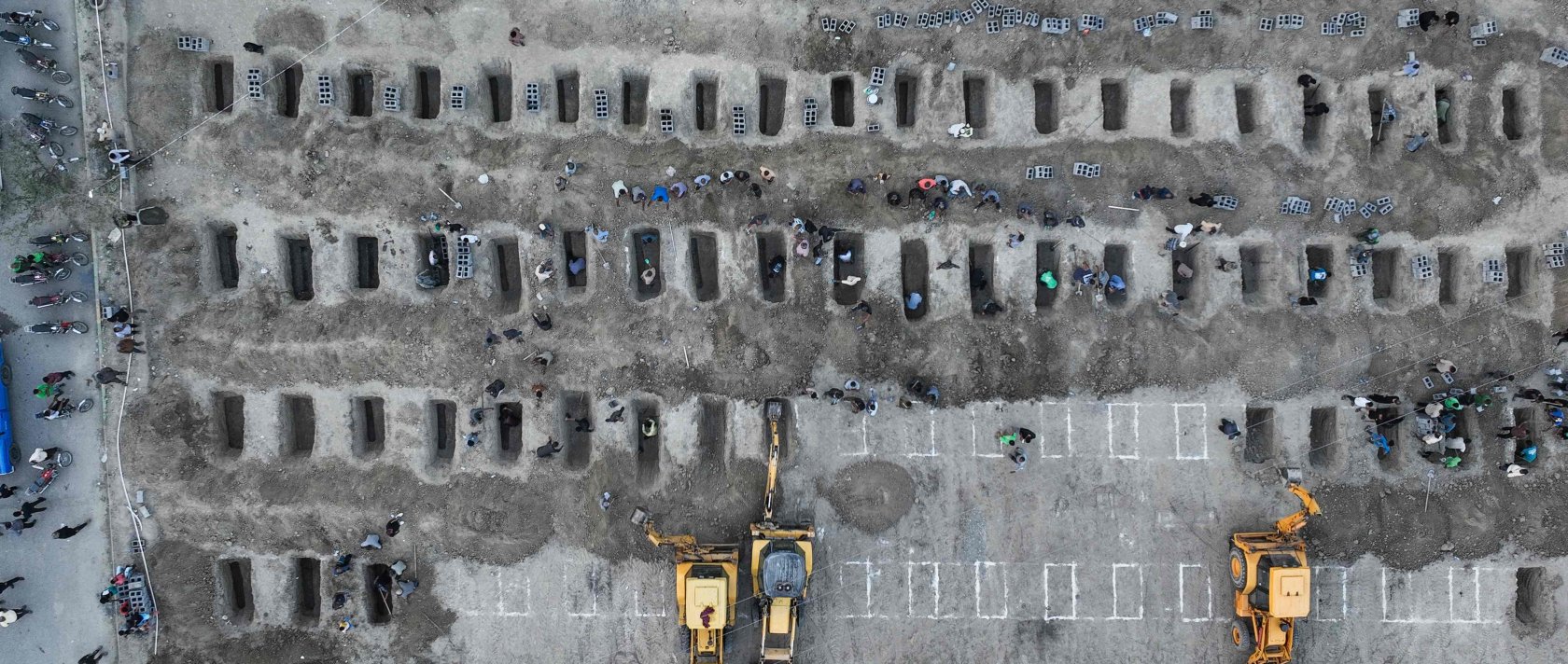 In this aerial handout picture released by the Iranian Press Center, mourners dig graves during the funeral for children killed in a reported strike on a primary school in Minab, Hormozgan province, Iran, March 3, 2026. (AFP Photo)