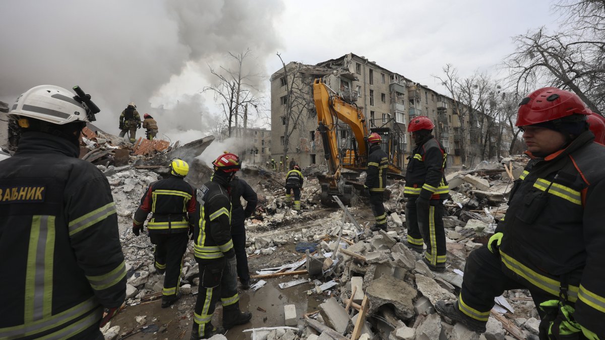 Ukrainian rescuers work at the site of a strike on a residential building in Kharkiv, northeastern Ukraine, March 7, 2026. (EPA Photo)
