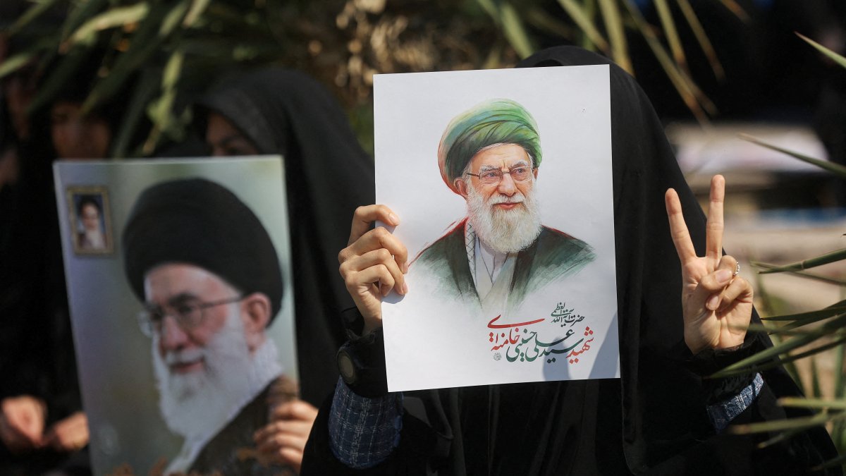 A woman gestures while holding an image of Iran's late Supreme Leader Ayatollah Ali Khamenei, on the day of an anti-Israeli and U.S. rally, amid the U.S.-Israeli conflict with Iran, in Tehran, Iran, March 6, 2026. (Reuters Photo)