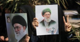 A woman gestures while holding an image of Iran's late Supreme Leader Ayatollah Ali Khamenei, on the day of an anti-Israeli and U.S. rally, amid the U.S.-Israeli conflict with Iran, in Tehran, Iran, March 6, 2026. (Reuters Photo)