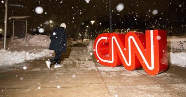 The CNN logo is seen as snow falls, Des Moines, Iowa, U.S., Jan. 10, 2024. (AFP Photo)