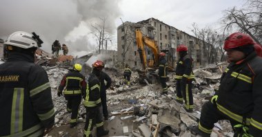 Ukrainian rescuers work at the site of a strike on a residential building in Kharkiv, northeastern Ukraine, March 7, 2026. (EPA Photo)