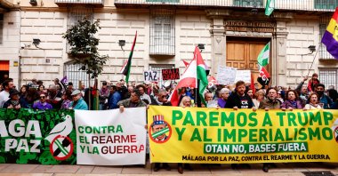 People hold banners that read, "Malaga for peace. Against rearmament and war" and "Stop Trump and imperialism. No to NATO, bases out," during an anti-war protest, Malaga, Spain, March 7, 2026. (Reuters Photo)