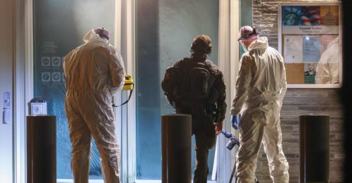 Forensic experts and a police officer stand in front the entrance of the U.S. embassy after a loud bang was reported during the night with no injuries reported in Oslo, Norway, March 8, 2026. (AFP Photo)