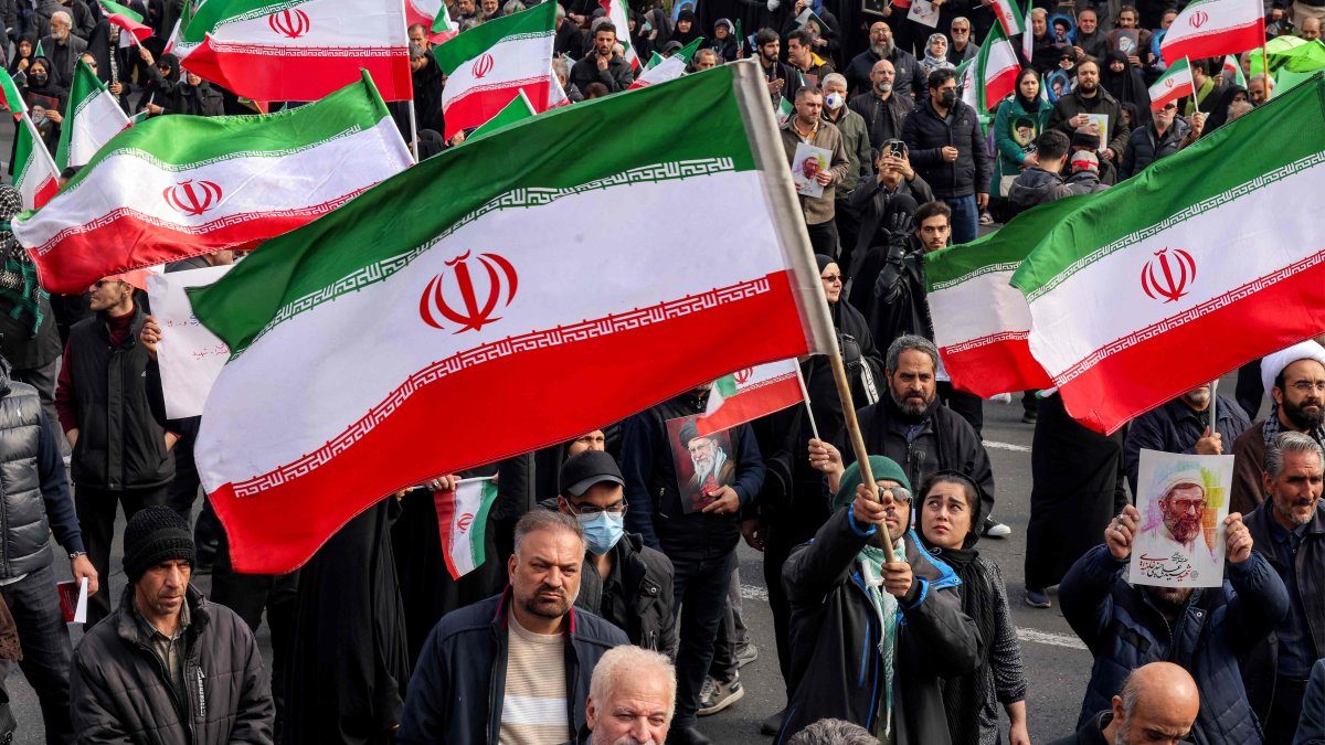 People with Iranian national flags rally in support of the new supreme leader in central Tehran, Iran, March 9, 2026. (AFP Photo)