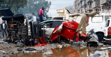 A man looks through the wreckage of vehicles destroyed following heavy rainfall and flood in the Grogan area of downtown Nairobi, Kenya, March 7, 2026. (Reuters Photo)