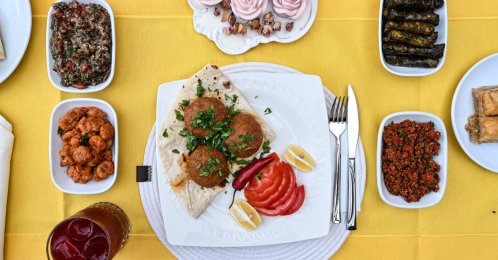 Adana içli köfte served with mezes on the table, Adana, southern Türkiye, Aug. 14, 2025. (AA Photo)