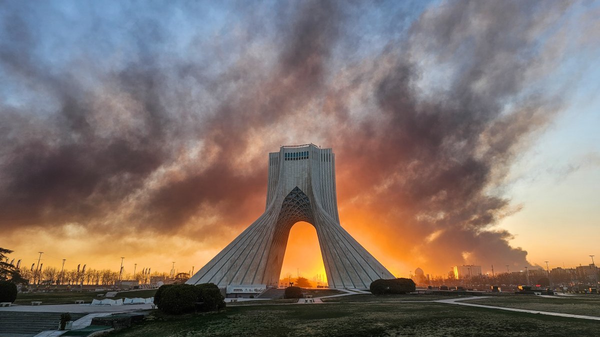 Smoke rises behind the Azadi (Freedom) monument in Tehran following the U.S.-Israeli military attack, Iran, March 3, 2026. (AP File Photo)