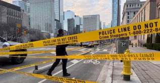 A member of law enforcement personnel works at the scene outside the U.S. Consulate after shots were fired, in Toronto, Ontario, Canada, March 10, 2026. (Reuters Photo)
