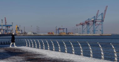 A pedestrian walks on the embankment of the sea port, Odesa, Ukraine, Feb. 19, 2026. (AFP Photo)