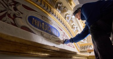 Restorer Domiziana Marchioro polishes the altar of St. Sebastian inside the Basilica of San Pietro in Vincoli, Rome, Italy, March 9, 2026. (AP Photo)